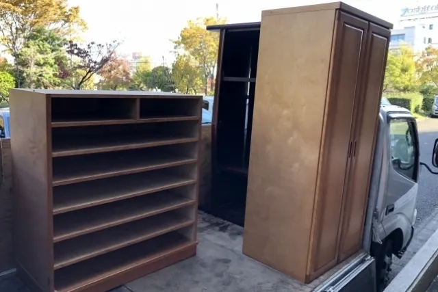 トラックの荷台に載せられた古いワードローブとタンス